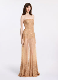 A long, strapless beige dress with bead embroidery, featuring a straight neckline.